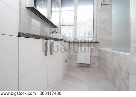 White Bathroom With A Window . Modern Apartment. Spacious Bathroom. White Shell. The Window In The B