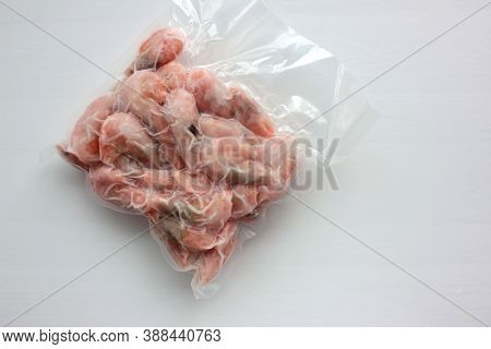 Boiled And Frozen Shrimps In Vacuum Transparent Plastic Packaging Bag On White Background.