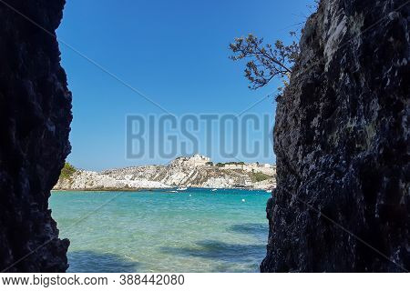 View Of San Nicola Island Trought The Rock Of Cala Delle Arene Beach In San Domino Island.
