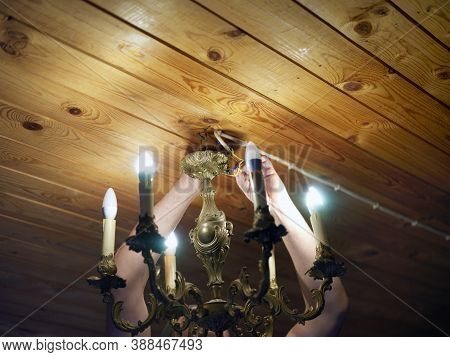Electrician Replacing A Bulb, Indoor Artificial Light Shot