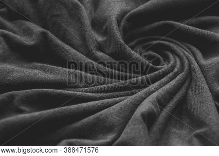 Close Up Picture Of Black Cotton Fabric Swirling With Wavy Holds, Textured Black Background For Fash