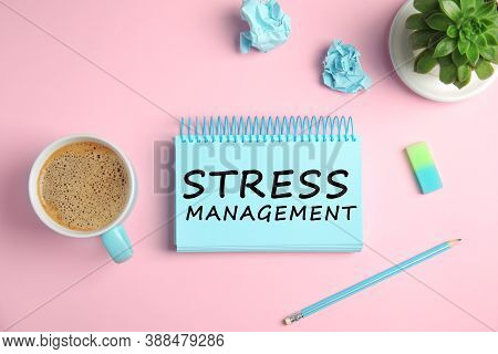 Text Stress Management In Notebook On Pink Background With Stationery And Cup Of Coffee, Flat Lay