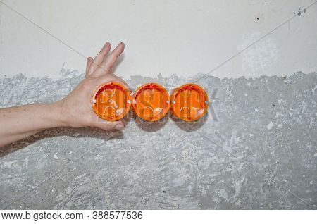 Socket Orange Boxes With Wires In Wall. Electrican Repair And Installing Socket Boxes. Outlet Plug. 