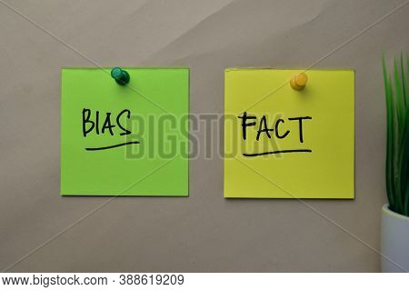 Bias And Fact Write On Sticky Notes Isolated On Office Desk.
