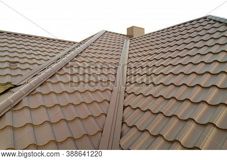 Detail Of House Roof Structure Covered With Brown Metal Tile Sheets.