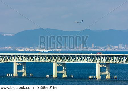 Osaka / Japan - November 16, 2017: Ana Plane Flying Over The Sky Gate Bridge, Landing At The Kansai 