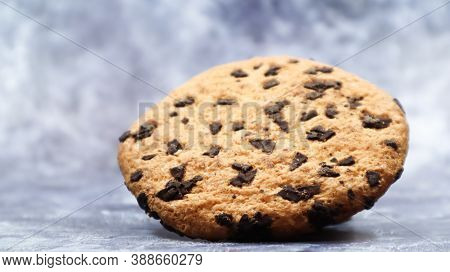 One Soft, Freshly Baked Chocolate Chip Cookie On A Gray Marble Kitchen Countertop. American Traditio