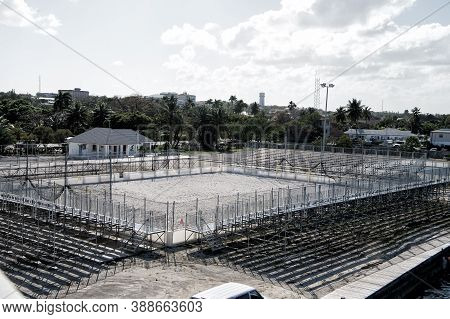 Empty Small Local Stadium Or Arena With Ground And Training Construction Near Tribunes And Palms Sun