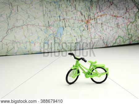 Toy Bike And World Map Guide In Background, Self-guided Travel Planning, Individual Tourism During I