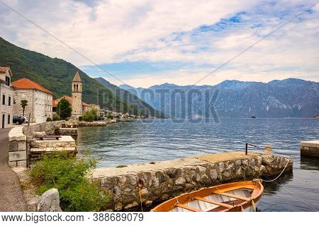 Picturesque Mediterranean Village With Stone Houses Against Gray Mountains, Montenegro, Bay Of Kotor