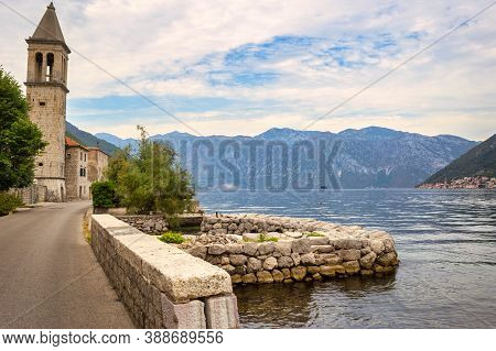 Picturesque Mediterranean Village With Stone Houses Against Gray Mountains, Montenegro, Bay Of Kotor