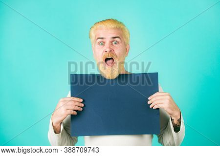 Portrait Of Excited Man Showing Blank Signboard With Copyspace Area For Slogan Or Text. Presentation