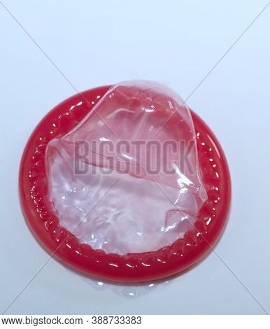 Red Condom Isolated On White Background, Sexually Transmitted Infection Prevention Concept And Contr