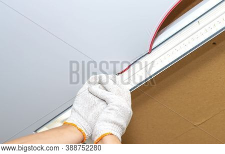 Process Of Installing Stretch Ceiling In The Hall. Close Up Of The Hand Of Man With A Tool.
