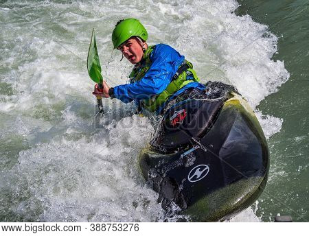 Augsburg, Germany - June 16, 2019: Whitewater Kayaking, Extreme Kayaking. A Guy In A Kayak Sails On 
