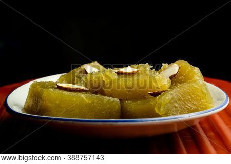 Indian Homemade Dessert Wheat Halwa Garnished With Badam On A Dark Background
