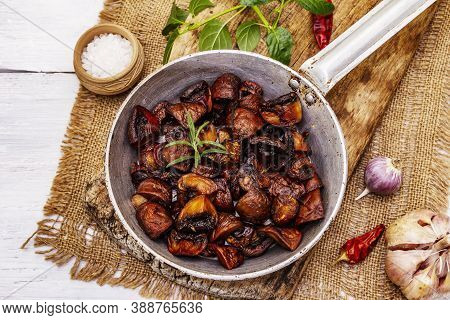 Ready To Eat Hot Fried Brown Champignons In Vintage Pan