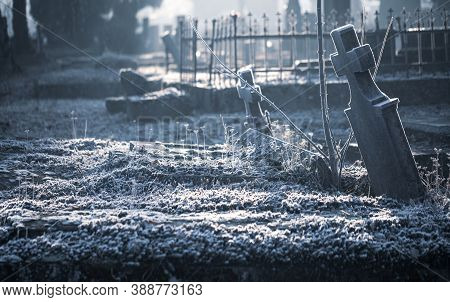 Old Cemetery Graveyard Tombstone Grave Cross Made Of Stone Or Marble Covered In Ice Frost On A Cold 
