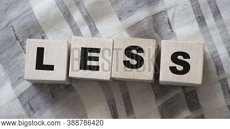 Less Word On Wooden Cubic Blocks With Letters. Spend Less Or Cut Costs Business Concept