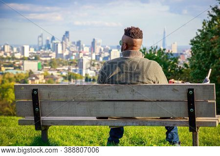 London, Uk - October 5, 2020 - Back View Of A Tourist Looking Over London City Skyline From Parliame