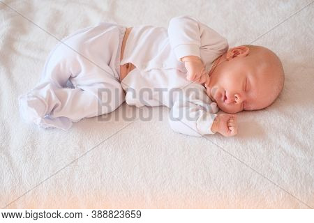 Portrait Of A Newborn Baby With Seborrhea Sleeping On A White Blanket.