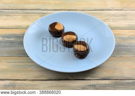 Buckeye Chocolate And Peanut Butter Balls Snacks On Blue Dessert Plate