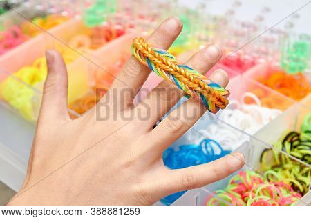 Rubber Band Weaving. Knitting Rubber Bands With Loom Knit. Hands Of Girl Hold A Wristband Of Rubber 