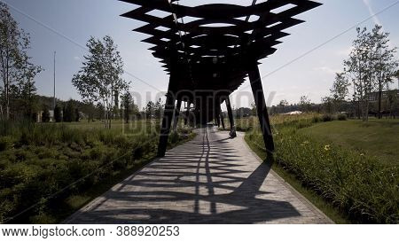 Walking Under The Unusual Wooden Construction Of Tyufeleva Roshcha Park. Action. Tuffel Grove Park, 