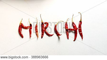A Picture Of Red Chilies With White Background Likes Written 