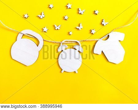 Childish Yellow Amber Background With Wooden Figures Representing The Date Of Birth, Weight And Heig