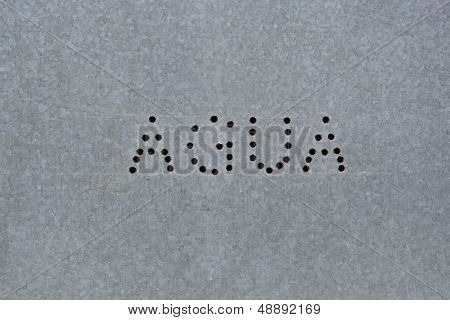 Spanish text agua on zink board