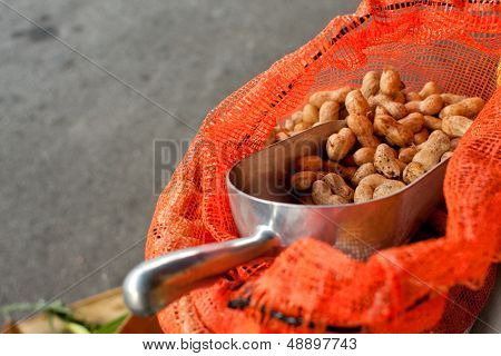 Scooper Full Of Peanuts Sits In Bag At Farmers Market