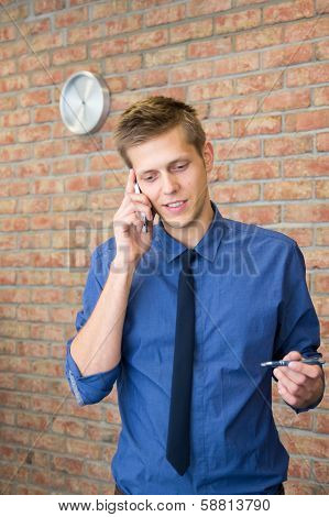 Young Businessman Talking On Phone.