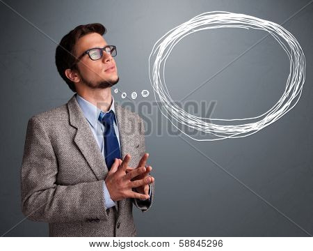 Good-looking young man thinking about speech or thought bubble with copy space