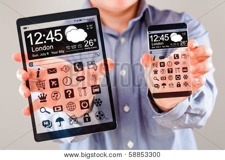 Smartphone (phablet) and tablet with a transparent display in human hands. Concept actual future innovative ideas and best technologies humanity.