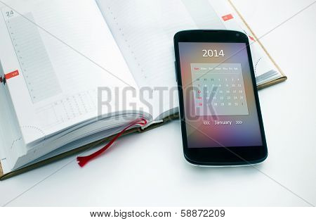 Modern mobile phone with calendar for 2014.