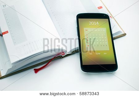 Modern mobile phone with calendar for june 2014.
