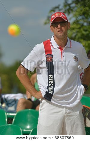 MOSCOW, RUSSIA - JULY 19, 2014: Captain of team Russia Stanislav Zaichenko watch the match Russia-Venezuela during ITF Beach Tennis World Team Championship. Russia won 2-1