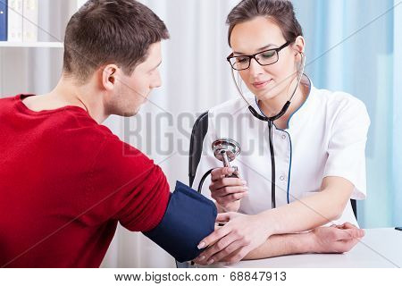 Doctor Checking Patient Pressure