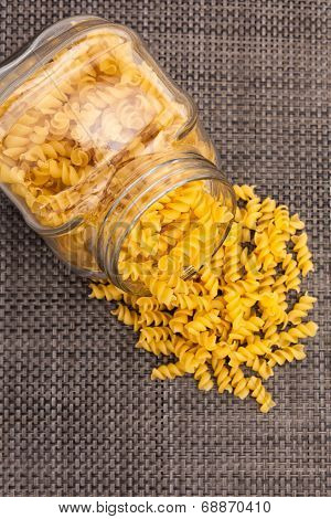 Fusilli in jar and on table