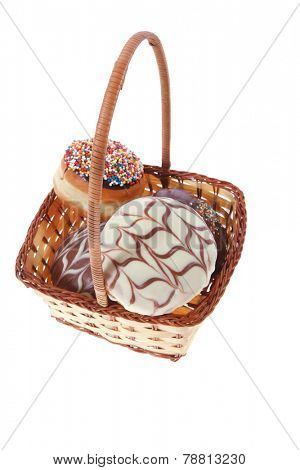 traditional jewish holiday chanuka donuts covered by dark and white chocolate pattern on retro vintage basket isolated on white background