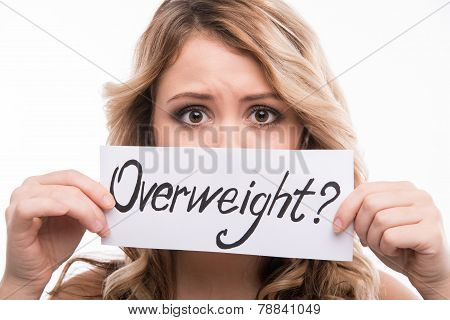 Portrait of young attractive woman holding warning notice card i