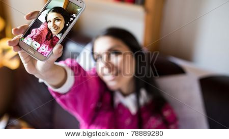 Happy pretty girl woman taking a selfie using smartphone,taking self portrait with her smart phone