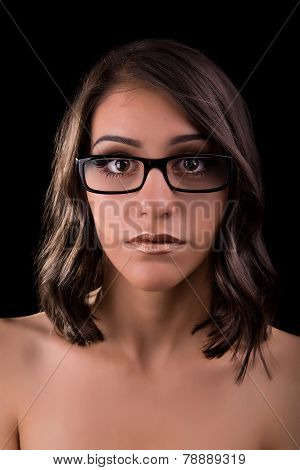 Young stylish attractive girl in optical glasses looking surprised with her eyes wide open