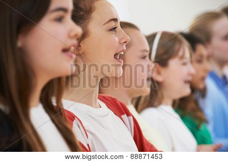 Group Of School Children Singing In Choir Together