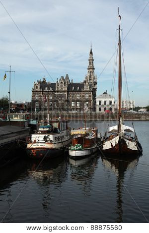 ANTWERP, BELGIUM - AUGUST 12, 2012: Yachts moored in the Bonaparte Dock next to the Pilotage Building (1894) in Antwerp, Belgium. 