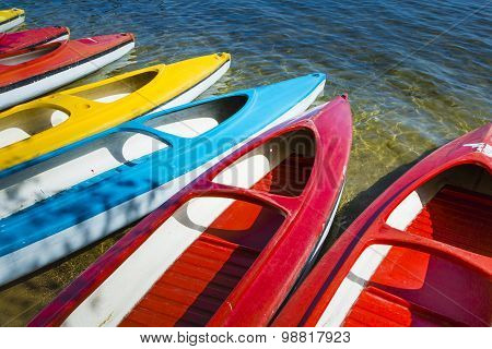 Colorful Kayaks Moored On Lakeshore, Goldopiwo Lake, Mazury, Poland.