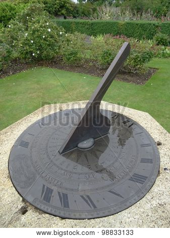 Garden Sundial Within Flowers And Trees