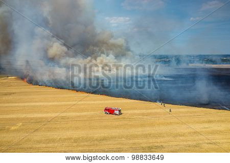 Fireman Truck Working On The Field On Fire