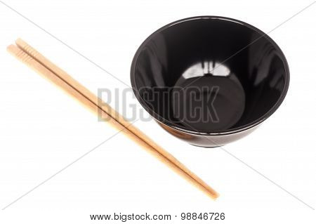 Black Ceramic Bowl With Wooden Shopsticks Isolated